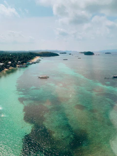 Crystal-clear waters and lush greenery of the Islas del Rosario with boats anchored nearby.