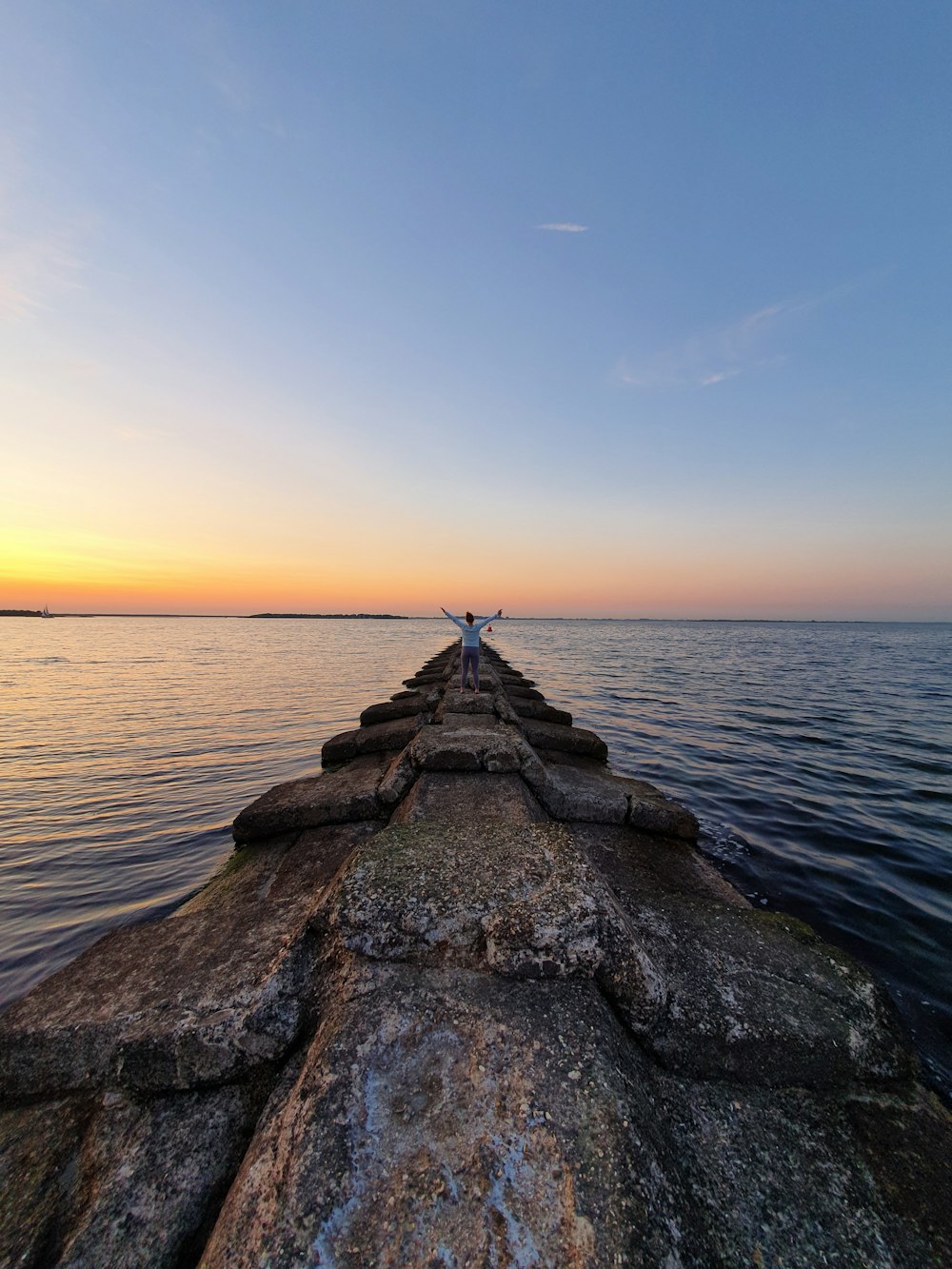 person standing on concrete dock