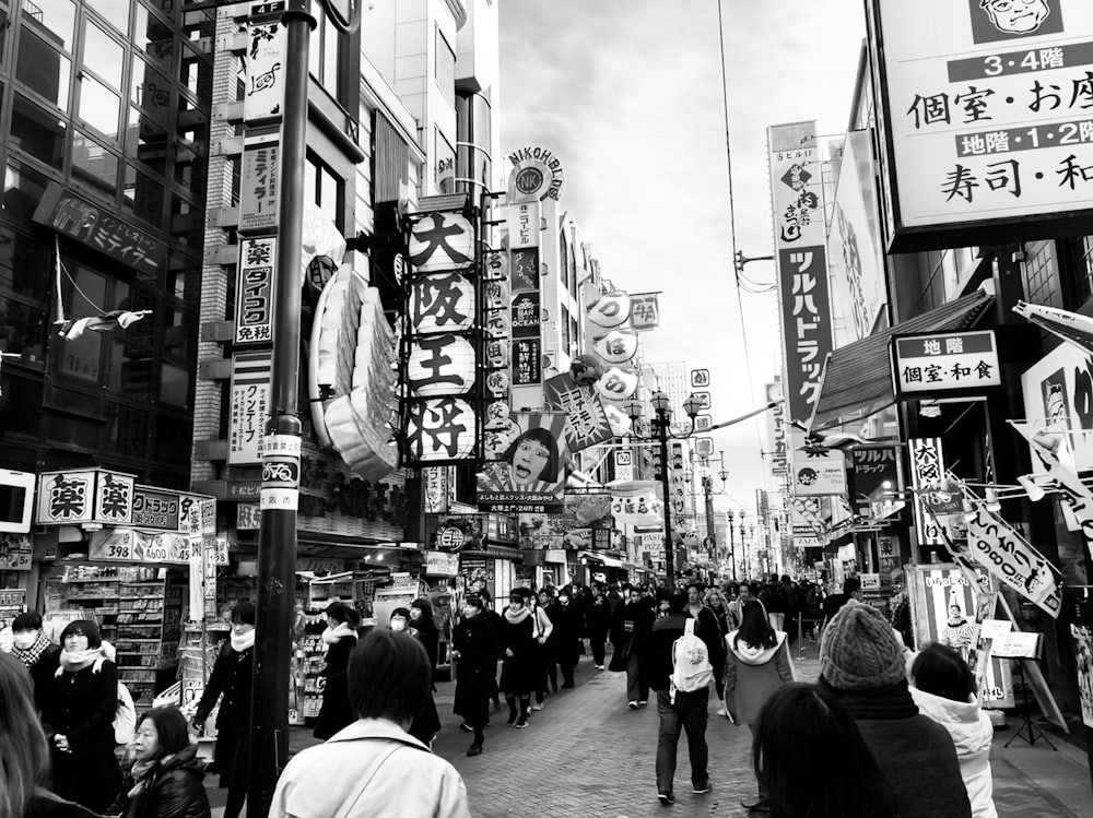 grayscale photography of road with crowd