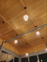 An inviting farmhouse living room featuring multiple lignoaura wooden pendants hanging at varying heights.