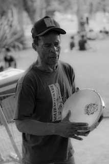 grayscale photography of man wearing fitted cap