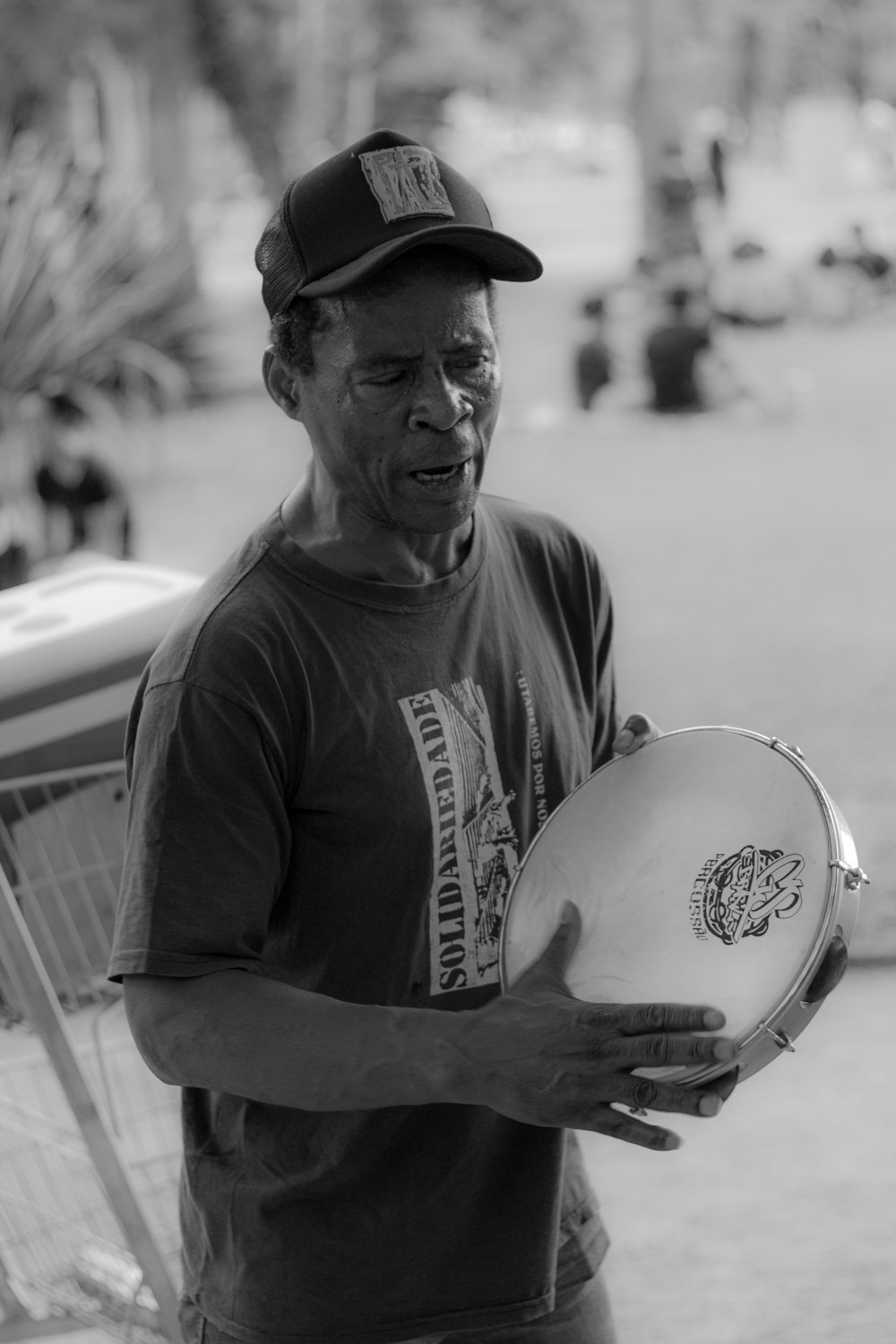 grayscale photography of man wearing fitted cap