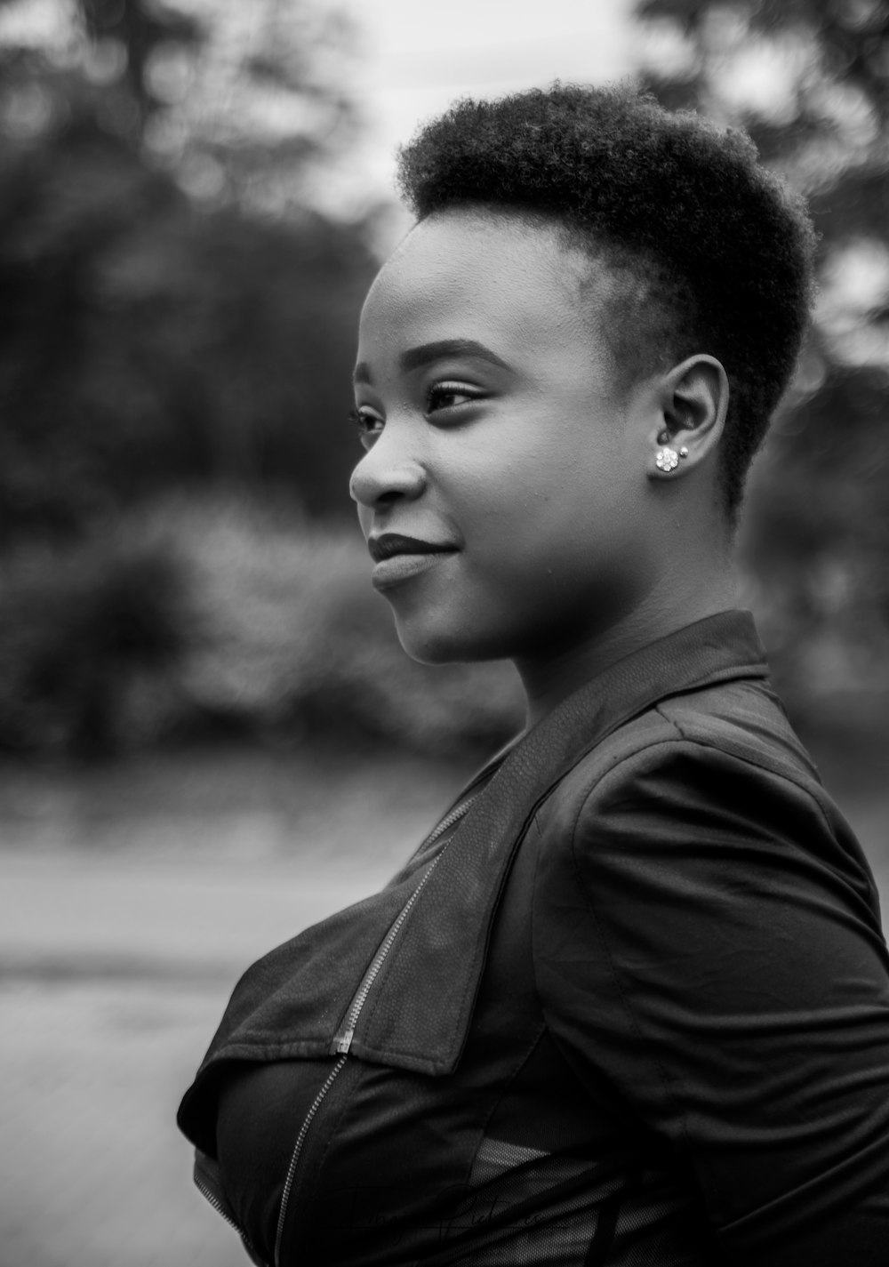 grayscale photography of woman wearing leather jacket