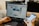 person using both laptop and smartphone