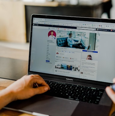 person using both laptop and smartphone