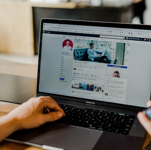 person using both laptop and smartphone