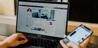 person using both laptop and smartphone