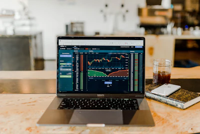 Laptop open on a desk showing market data