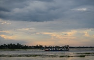 A group of travelers sharing a joyful moment during a sunset boat ride on the Godavari river.
