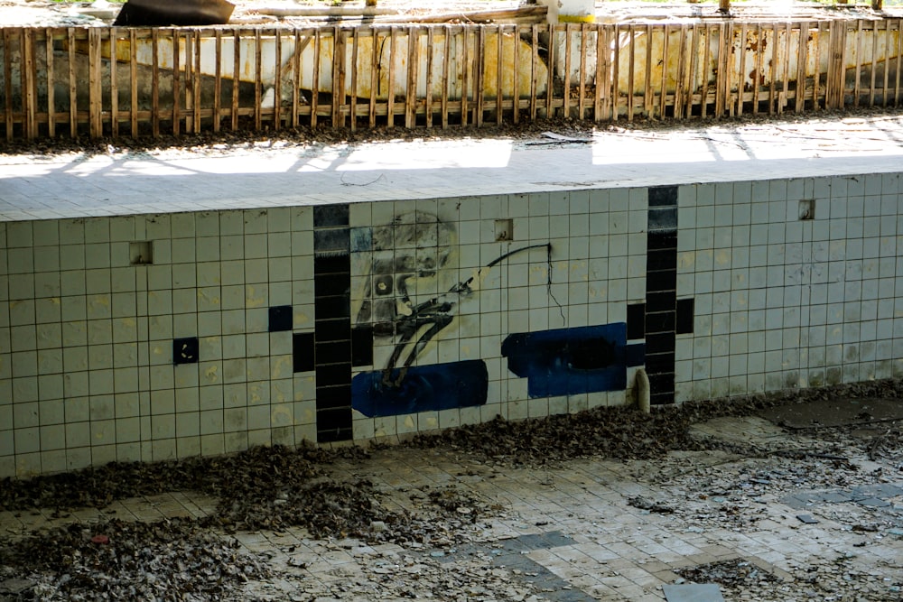 a public bathroom with a graffiti on the wall