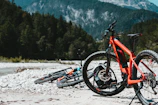 A lineup of colorful e-bikes ready for a day of exploration against a mountain backdrop.