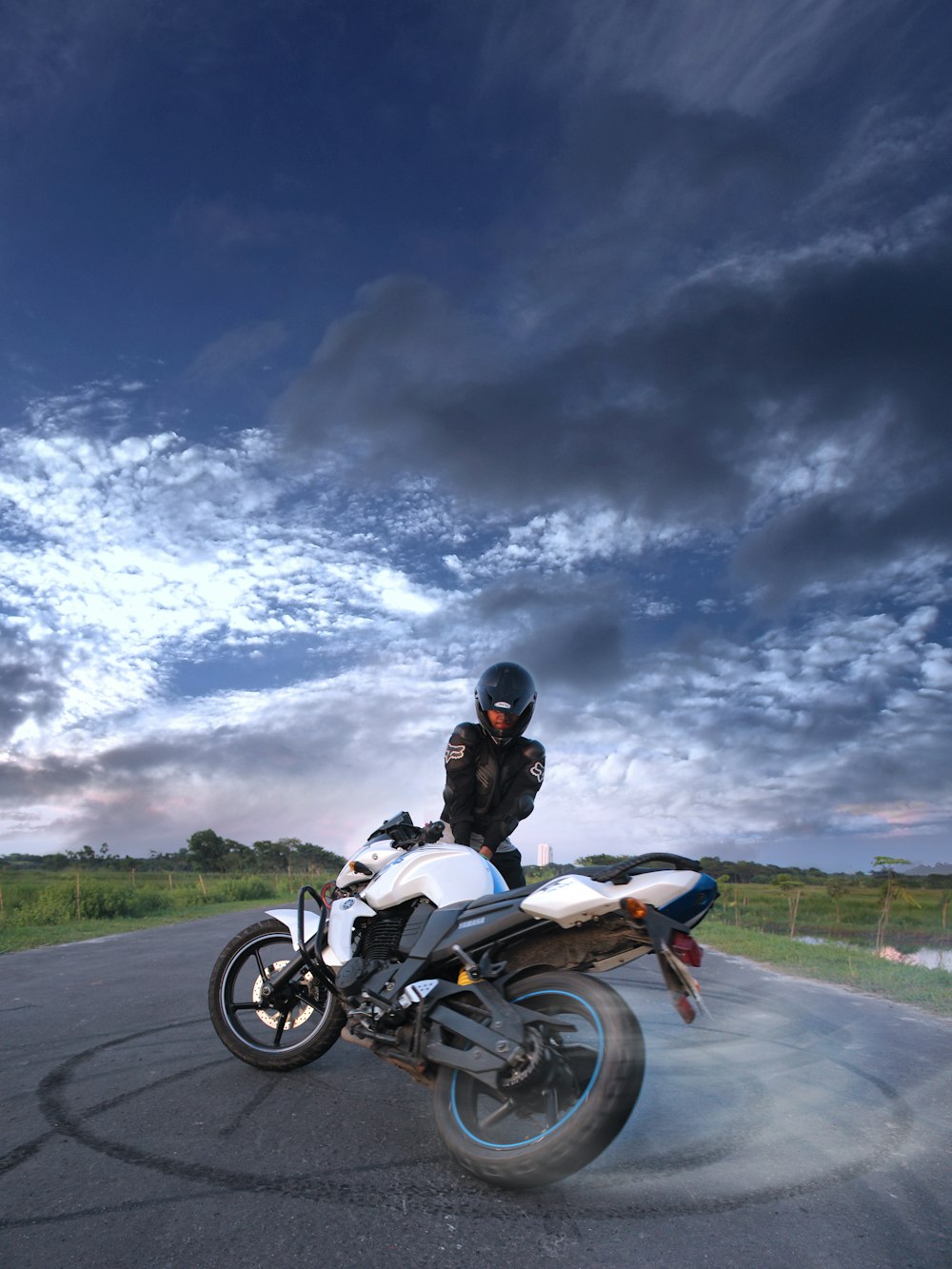 person standing beside sports bike