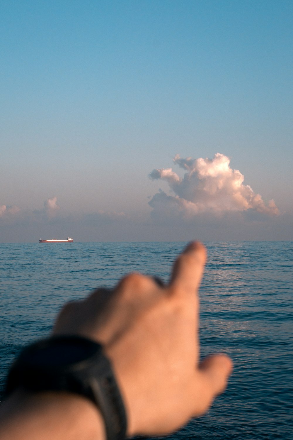 left person's hand pointing on white cloud