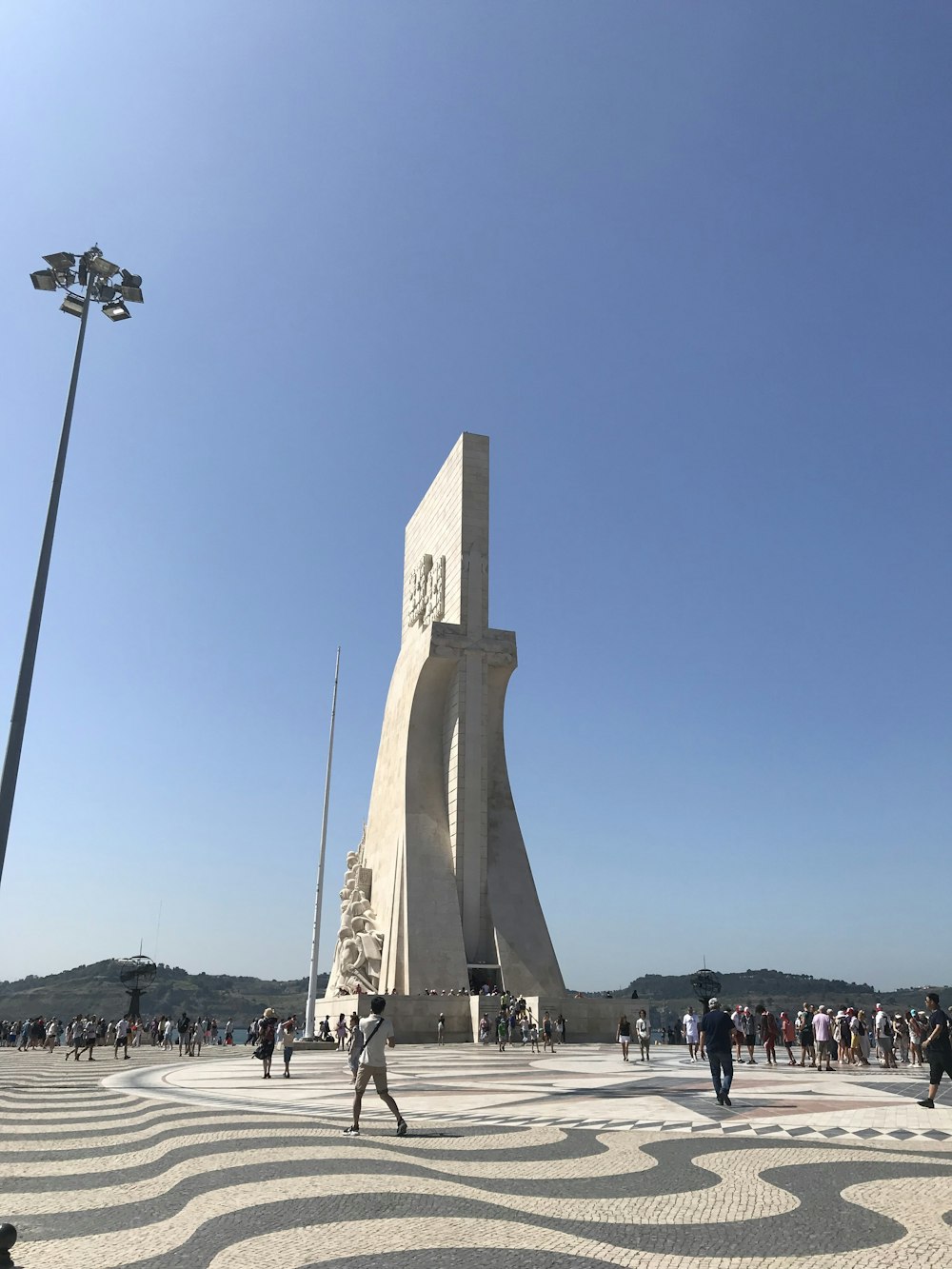 people standing beside white tower during daytime