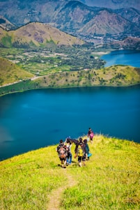 Group of hikers overlooking a mountain lake at sunrise