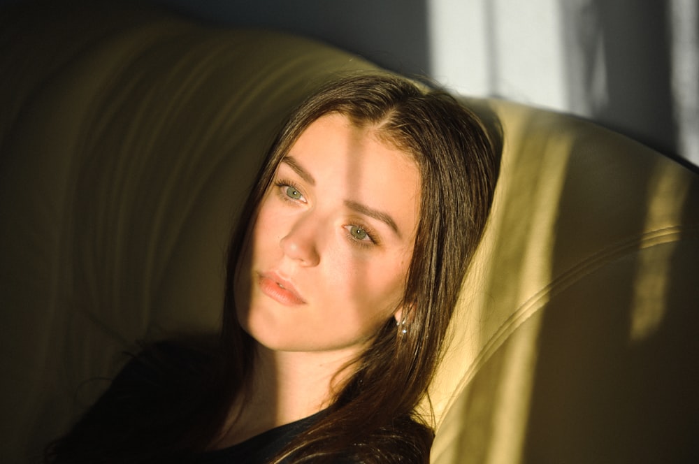 woman sitting on brown sofa