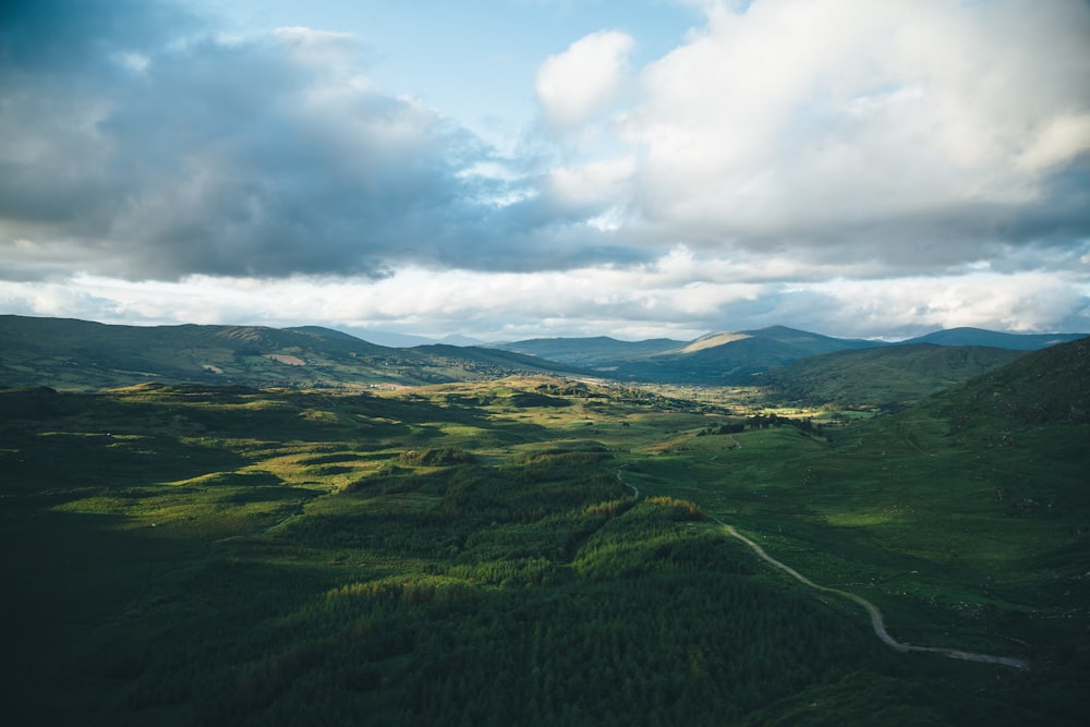 green mountains under white and blue sky at daytime