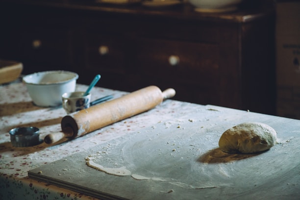 A cozy kitchen scene showing dough rising in a bowl next to a vintage oven.