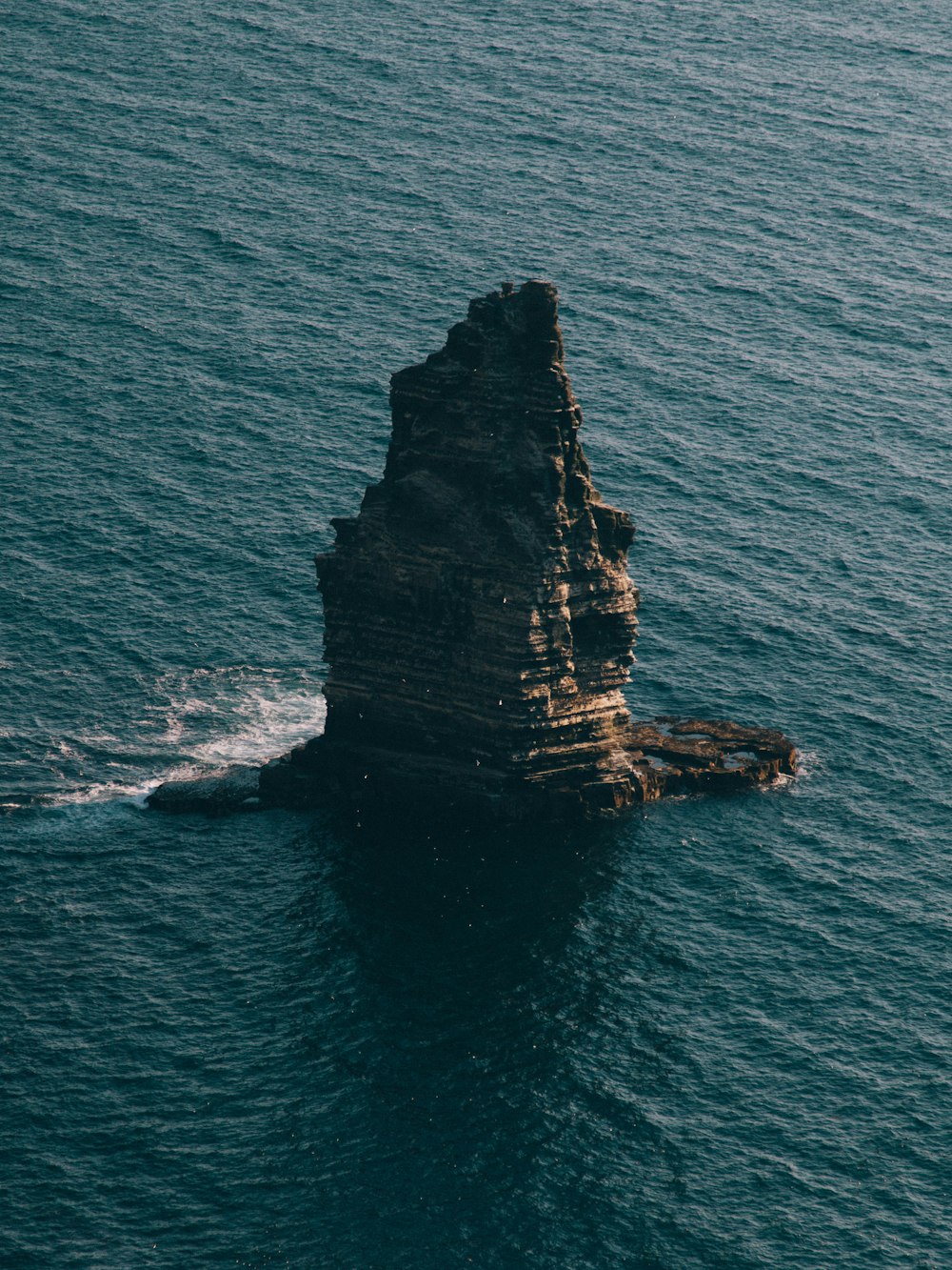 gray stone and body of water