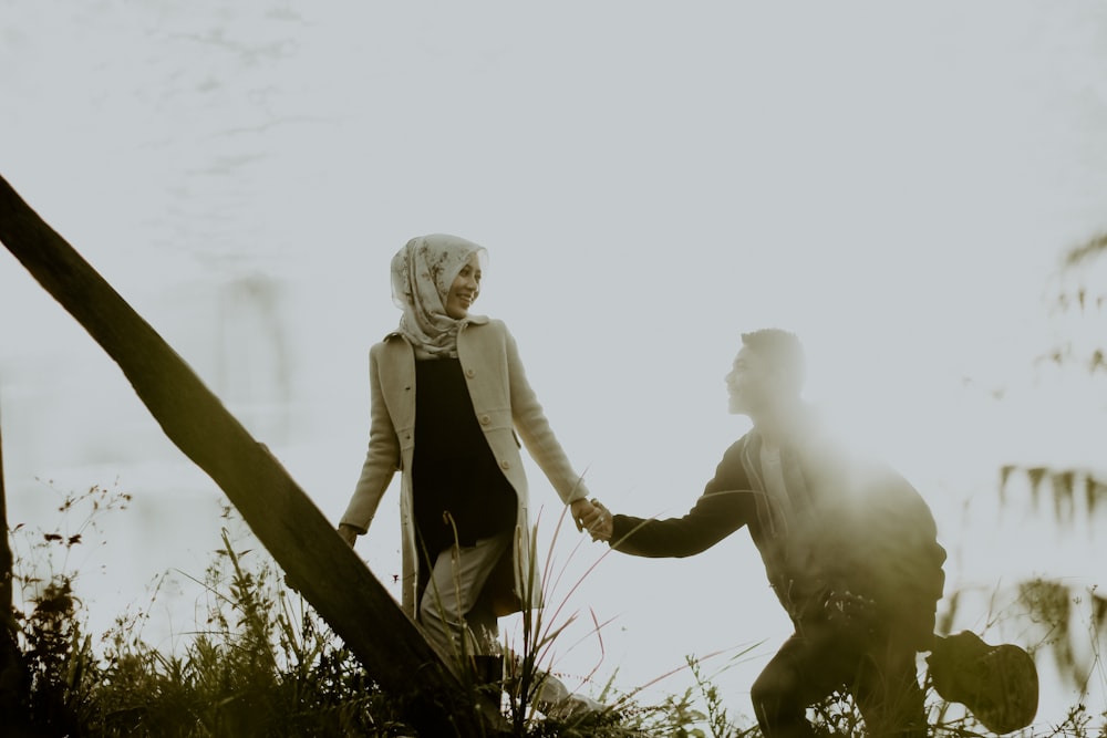 couple holding hands during daytime