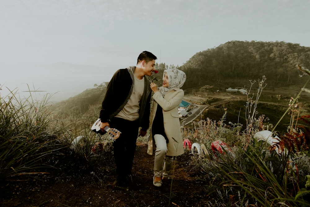 two person in a hill during daytime