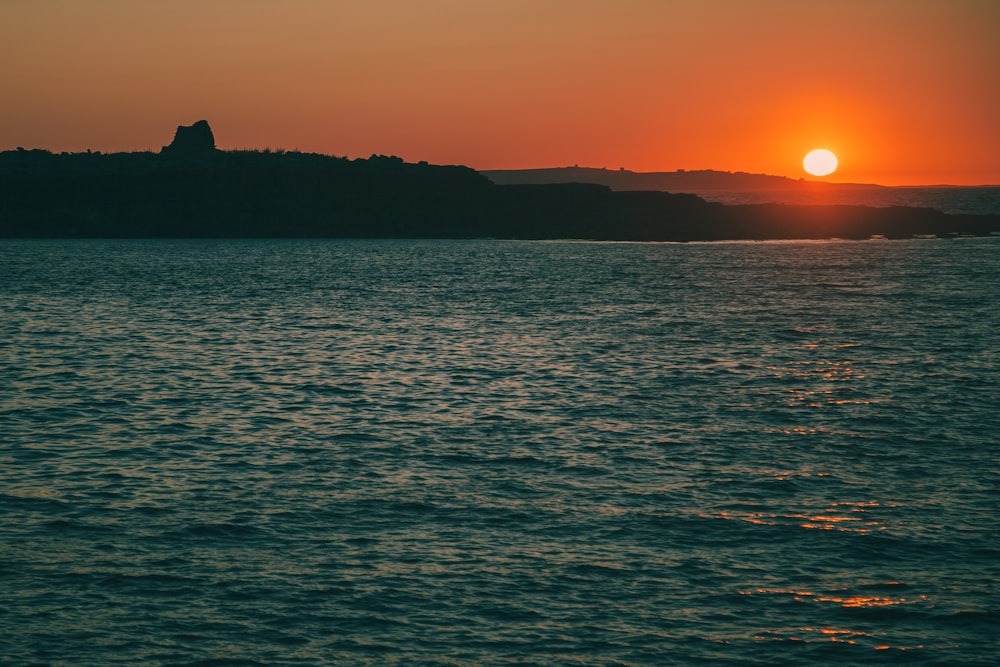 body of water during golden hour