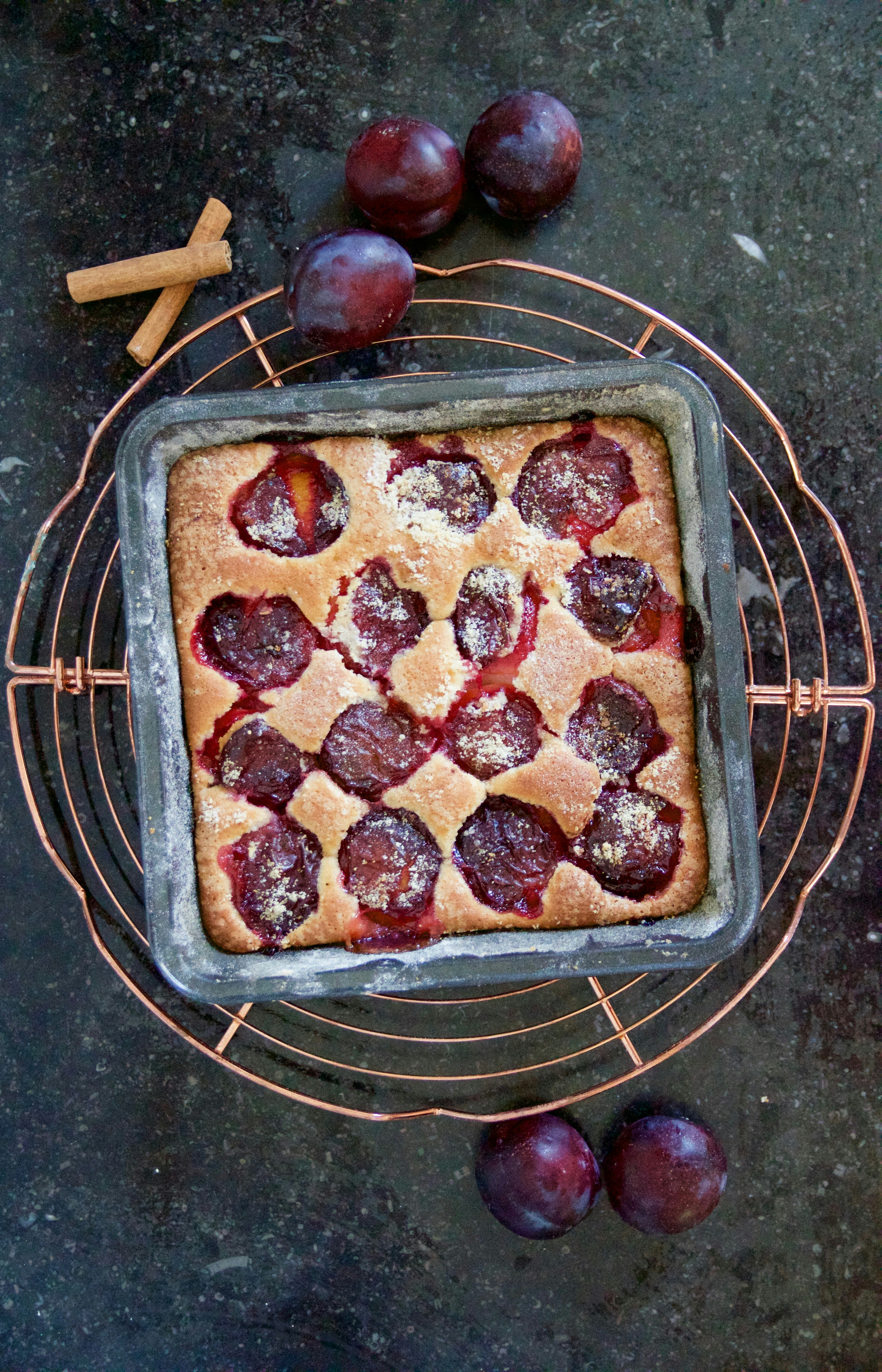 plum fruits and plum pie on black bowl