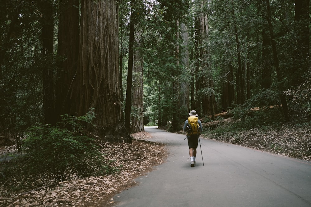 man walking on road