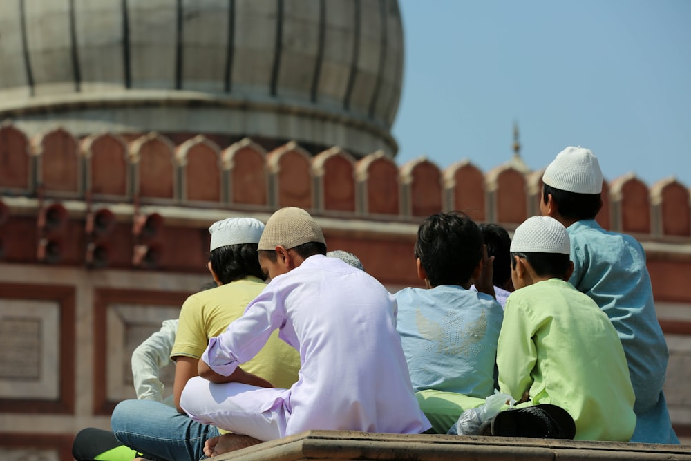 group of men sitting near structure