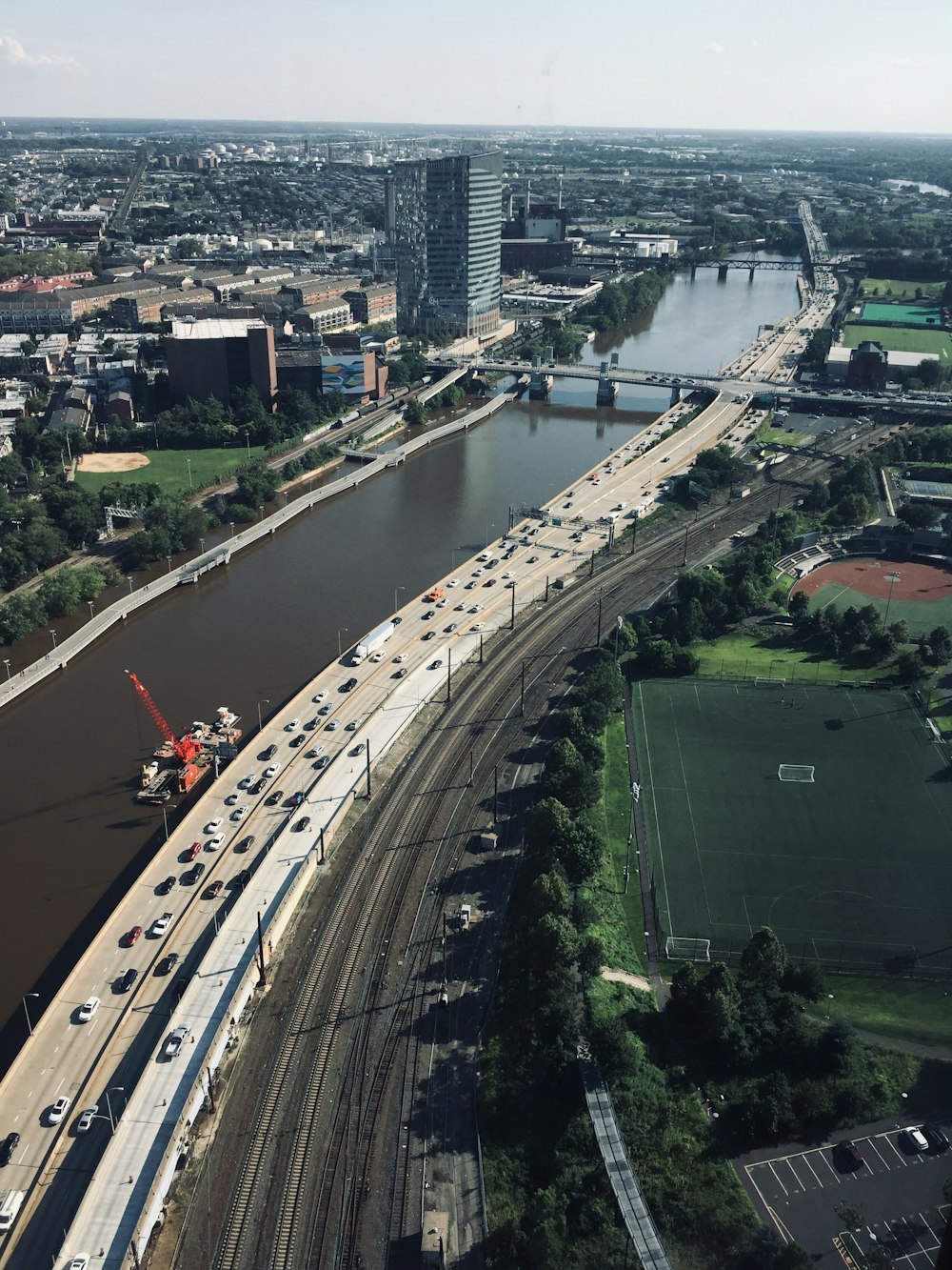 vehicles on highway beside body of water during daytime