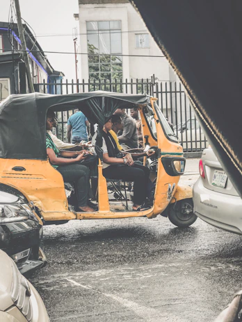 Happy passengers stepping out of a spacious Innova taxi at a bustling city street in Raipur.
