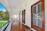 Close-up of a spotless, freshly cleaned white porch with shining railings.