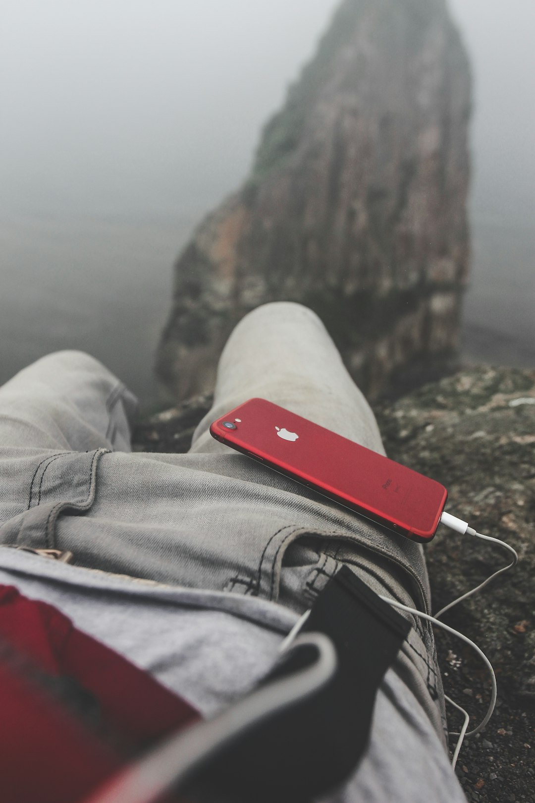 PRODUCT RED iPhone on person's lap