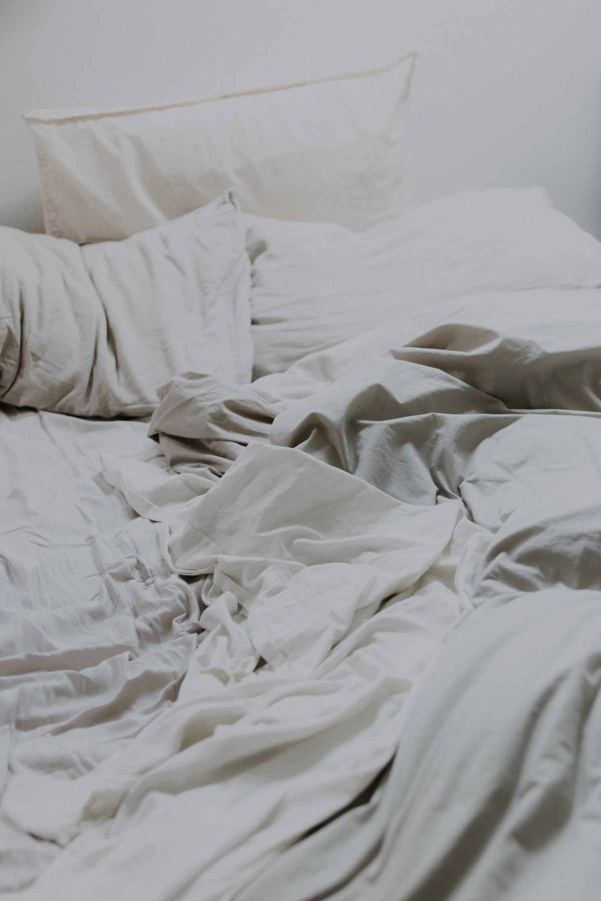 White sheet set, pillowcases, pillows, and comforter displayed on a bed