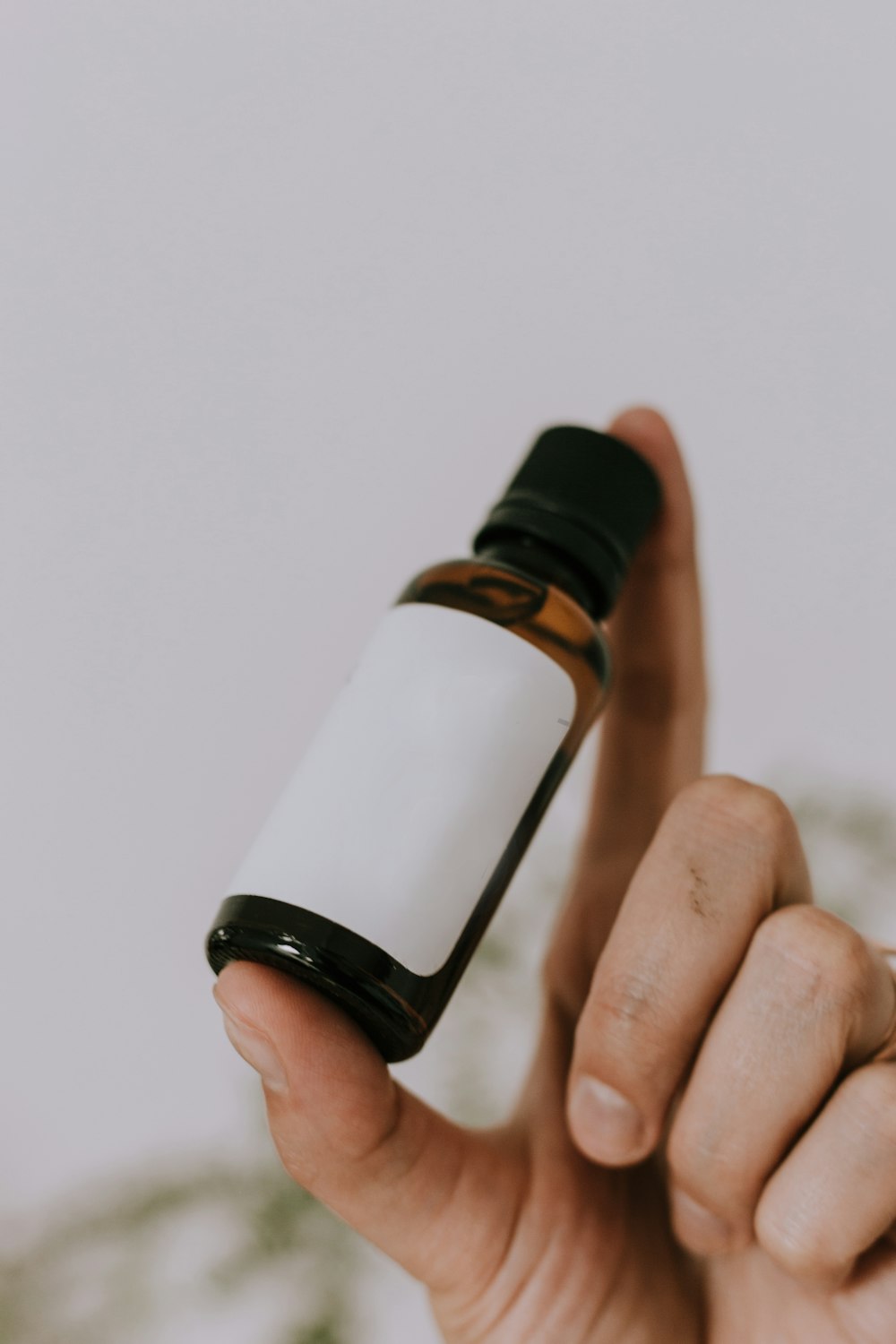 white and brown glass bottle