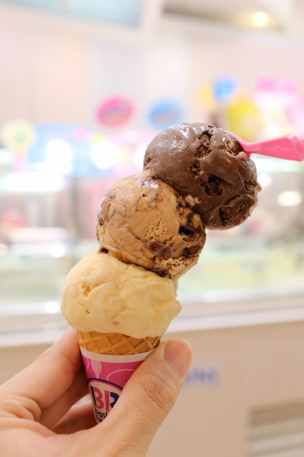 three scoop of ice cream on sugar cone