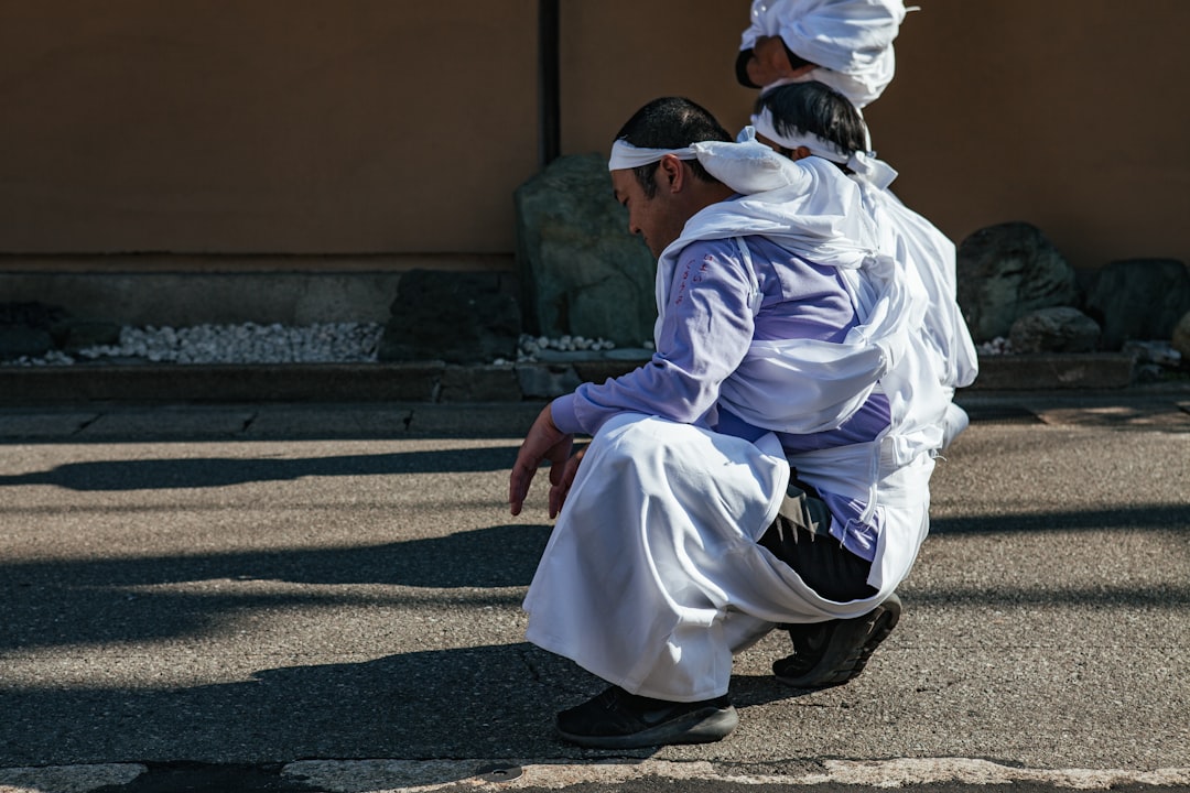 man sitting on pavement