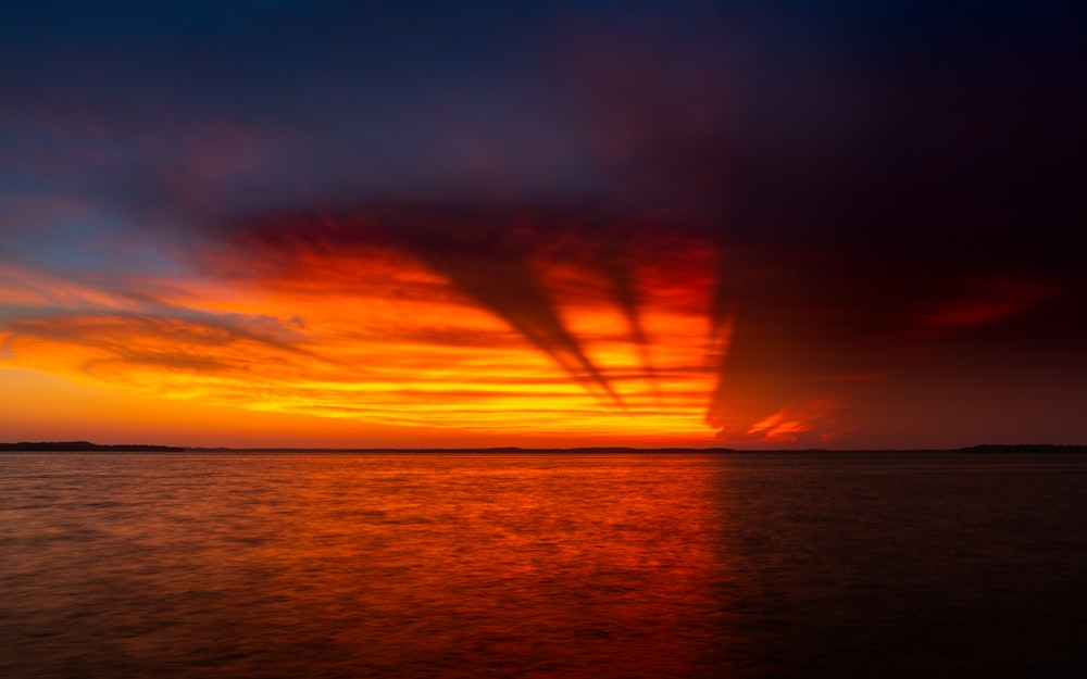 calm body of water during golden hour