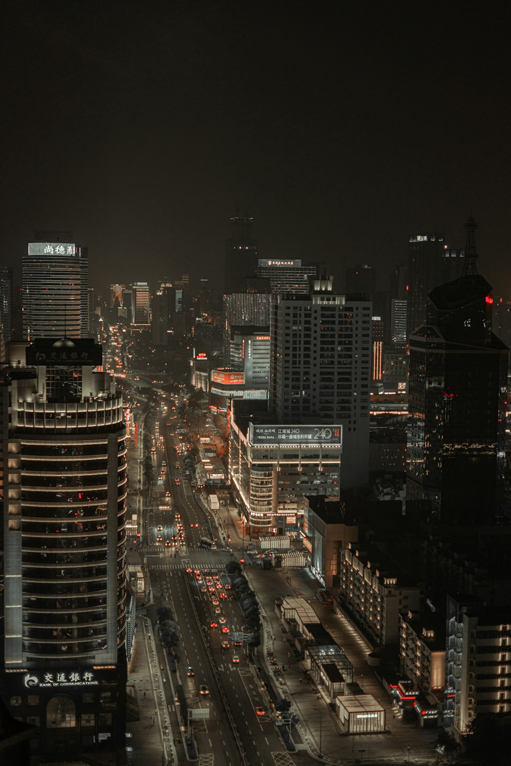 city buildings and traffic lights during nighttime