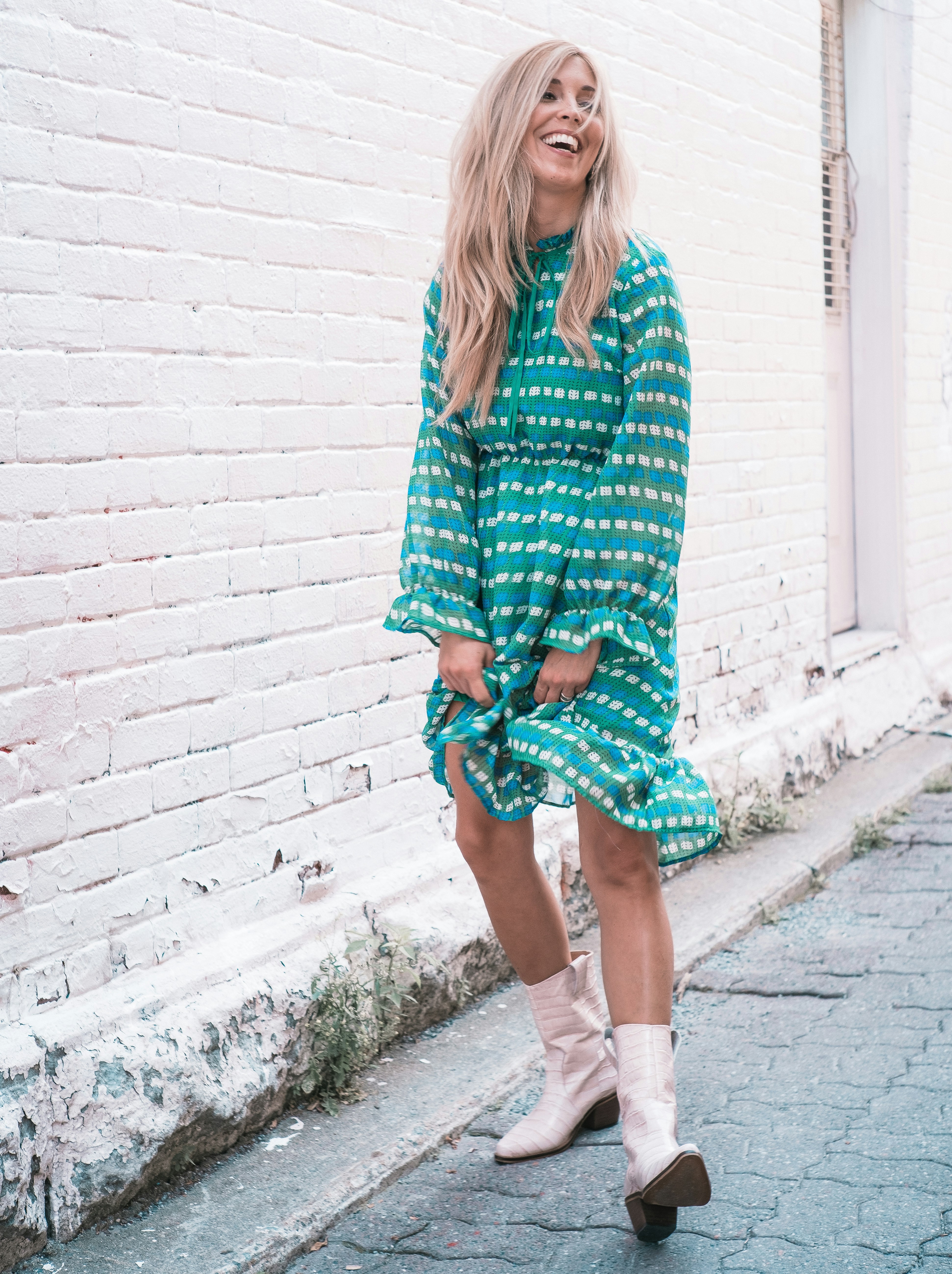 woman wearing teal and white long-sleeved dress