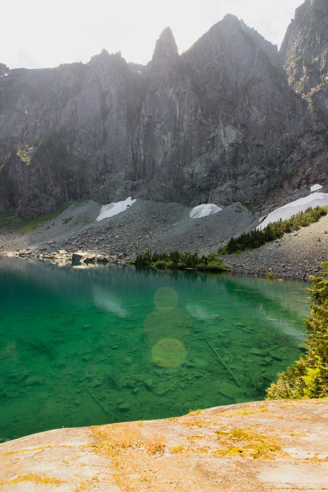 body of water near mountain at daytime