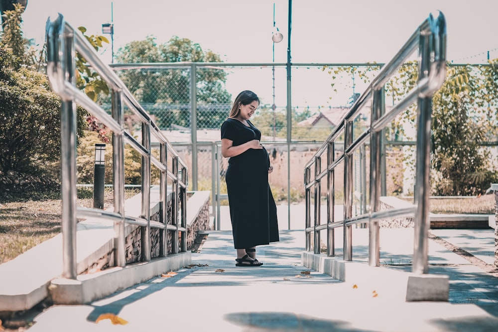 pregnant women wearing black dress during daytime