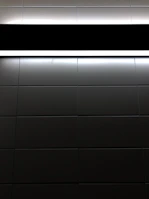 Glossy black and white checkerboard tiles reflecting soft ambient light.