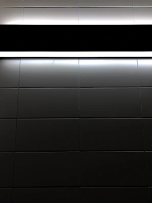 Glossy black and white checkerboard tiles reflecting soft ambient light.