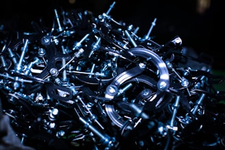 Close-up of shiny metal scraps piled together in a warehouse.