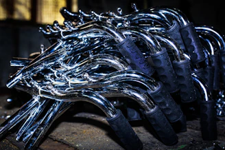 Shiny quad bike parts arranged neatly on a workbench.