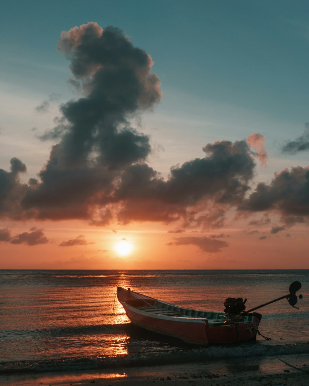 red boat and clouds