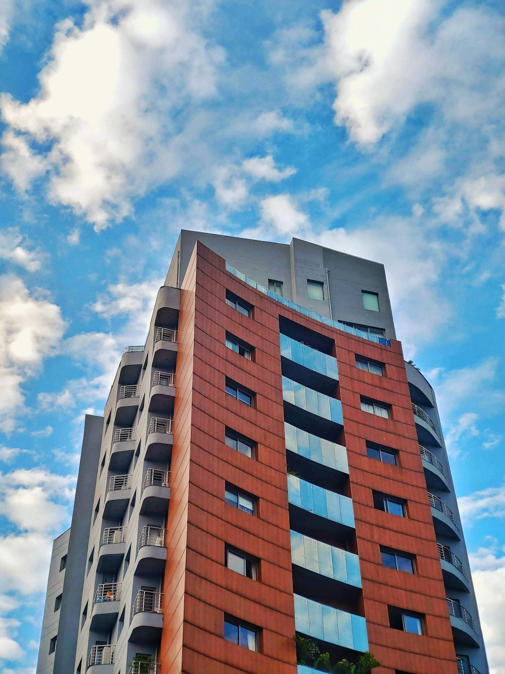 low angle photography of orange and gray high rise building