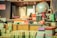 An assortment of vintage office and stationery items arranged on a desk, including boxes of crayons, a globe, stacked papers, stamps, and various labeled packages. The items have a nostalgic and old-fashioned charm, with visible text and colorful designs on the packaging.