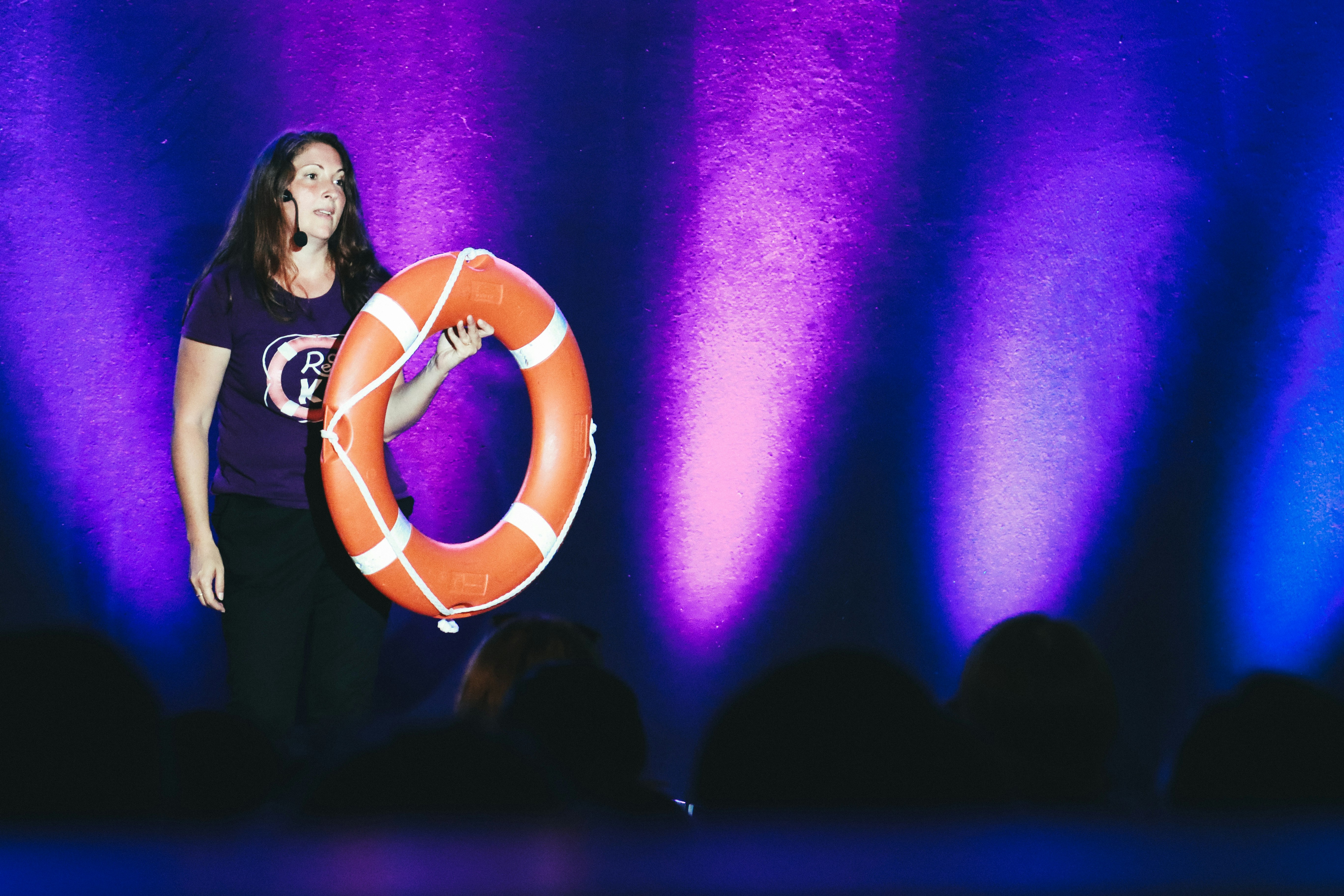 unknown person holding orange inflatable buoy